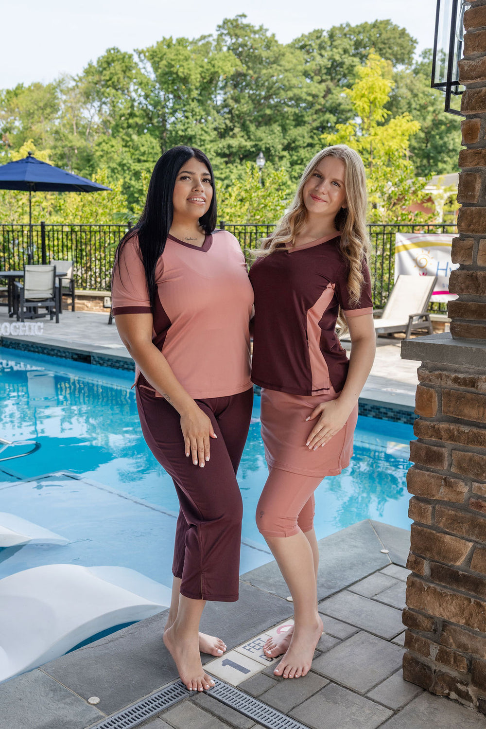 Women relaxing poolside in HydroChic modest swimwear